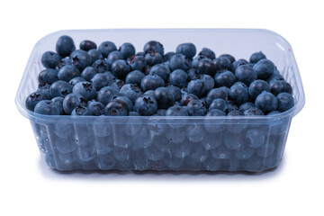 Blueberries in a plastic container isolated on white background.