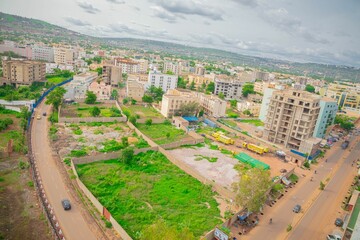 Beautiful cityscape in Republic of Mali with residential buildings,trees,busy street and gray sky