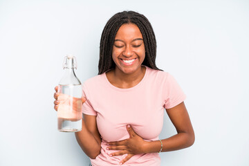 black pretty woman laughing out loud at some hilarious joke. water bottle concept