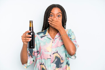 black pretty woman covering mouth with hands with a shocked beer and holidays concept