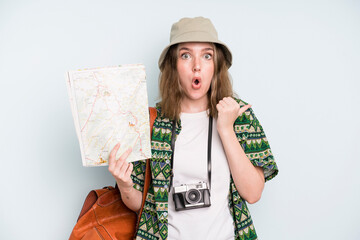 caucasian pretty woman looking astonished in disbelief. backpacker tourist with a map