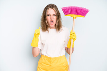 caucasian pretty woman shouting aggressively with an angry expression. housekeeper cleaning concept
