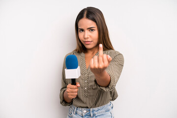 hispanic pretty woman feeling angry, annoyed, rebellious and aggressive. presenter with a...