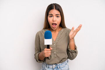 hispanic pretty woman feeling happy, surprised realizing a solution or idea. presenter with a...