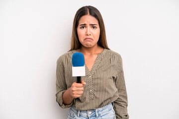 hispanic pretty woman feeling sad and whiney with an unhappy look and crying. presenter with a...