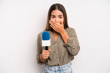 hispanic pretty woman covering mouth with hands with a shocked. presenter with a microphone concept