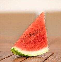 Piece of watermelon on a wooden table