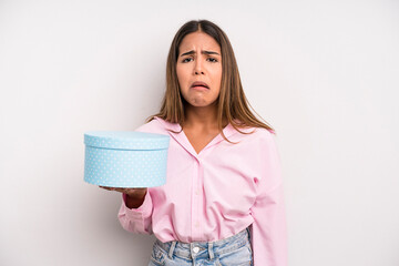 hispanic pretty woman feeling sad and whiney with an unhappy look and crying. gift box concept