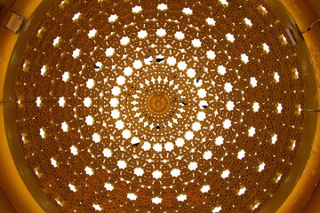 Low-angle shot of a golden beautiful dome from an indoor view