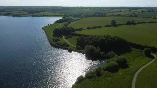 Aerial view of the sunny Pitsford Reservoir in Northamptonshire, UK