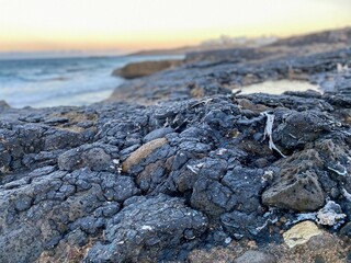 Closeup of tar pollution on a rocky shore in Tenerife