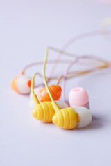 close up of colorful earphone on white background 