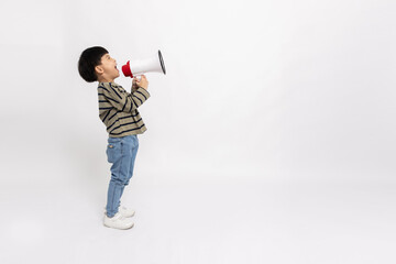 Side of Asian little boy standing and holding megaphone isolated on white background, Speech and...