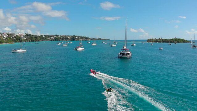Drone shot of luxury catamaran yachts and small speedboats towing in the sea of Caribbean