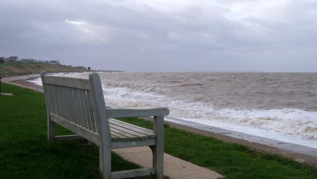 Wooden bench by the sea in a Stormy weather in Herne Bay, Kent, United Kingdom