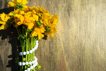 yellow flowers on wooden background