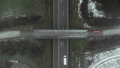 Aerial top view of road under bridge in a misty day