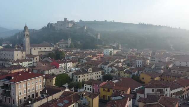 Drone footage over the Veneto winery city and castle under the blue sky