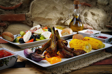 Rack of lamb with corn and Greek salad. Homemade food. Rustic.
