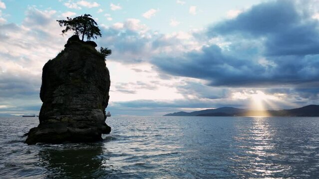 Beautiful view of the sea under a cloudy sky during sunset in Vancouver, BC, Canada
