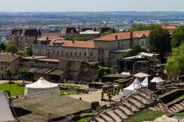 Roman ruins of the Theatre of Fourviere in Lyon, France with park and cityscape in the background