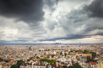 Fototapeta na wymiar Above Paris from Sacre Couer tower in Montmartre with dramatic sky, France