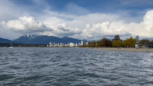 Low-angle view of Kitsilano Beach under a cloudy sky