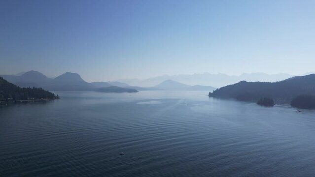 Aerial view of a calm lake surrounded by trees and mountains in Gibsons, BC, Canada