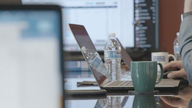 Film Pan of Men in Suits With Laptops in Corporate, Business Meeting