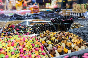 licorice gummy colored candies on a street stall during a folk festival in italy