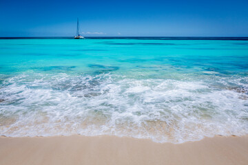 Fototapeta na wymiar Tropical paradise: idyllic beach with sailboat, Punta Cana, Dominican Republic