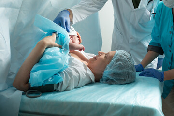 Mother look to her newborn baby in hospital - 525647224