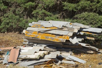 Broken Asbestos Cement Sheets with Asbestos Waste fly tipping Group of broken and fibrous slice