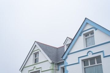 white pastel houses with cloudy sky tintagel cornwall england