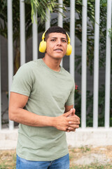 Portrait of a freckled young man with headphones looking at the camera.