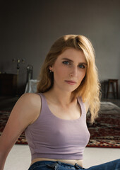 Fototapeta premium A girl in an atmospheric studio in a light key