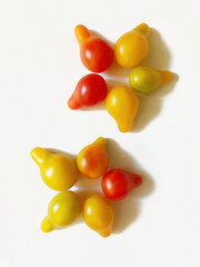 floral ornament made from yellow and red pear-shaped cherry tomatoes