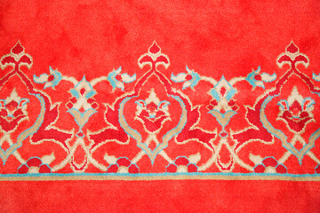 Old Turkish red carpet with geometric and floral decorations