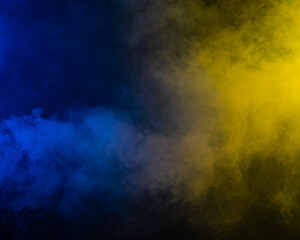 Yellow-blue smoke in neon light on black background.