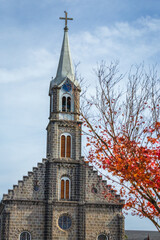 Fototapeta na wymiar Gramado stone church at golden autumn, Gramado, Southern Brazil