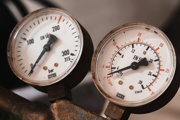 Closeup of manometers on a rusty pipe