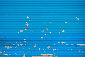 Gray painting's drops on a blue wall