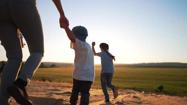 Happy family concept.Child run hand to the sides in park.Child play with dog in field on green grass.Family games of friend at sunset.Dream kid in summer in park.Family jogging in green grass with dog