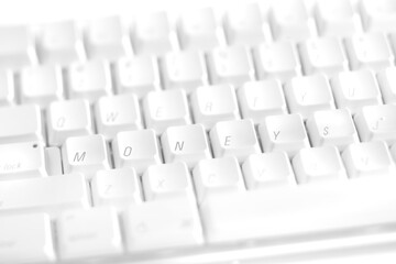 White computer keyboard keys reorganized to spell outthe word MONEY