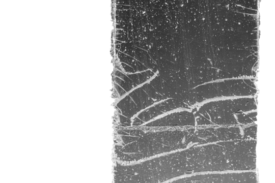 Strip of tape adhesive on a glass surface after being pulled.  