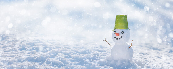 Christmas winter banner with snowman on snow background in winter forest. Holiday background with...