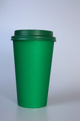 Green paper cup on a white background. Coffee to go. Coffee mug to go.