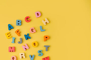 Colorful letters of the alphabet on yellow background. Primary school or preschool, kindergarten....
