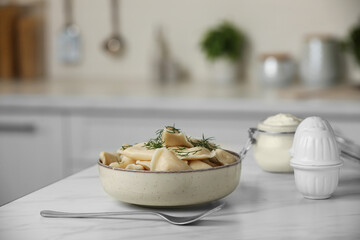 Delicious dumplings with dill on table in kitchen, space for text