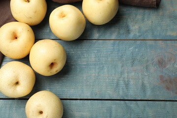 Ripe apple pears on blue wooden table, flat lay. Space for text